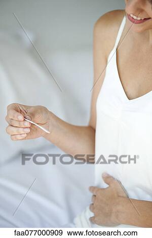 Woman holding pregnancy test, cropped View Large Photo Image Stock Photo - Woman holding pregnancy test, cropped. Fotosearch