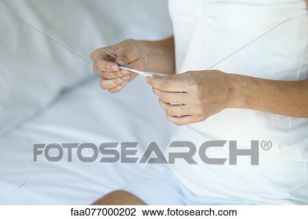Woman holding pregnancy test, mid section View Large Photo Image Stock Image - Woman holding pregnancy test, mid section. Fotosearch