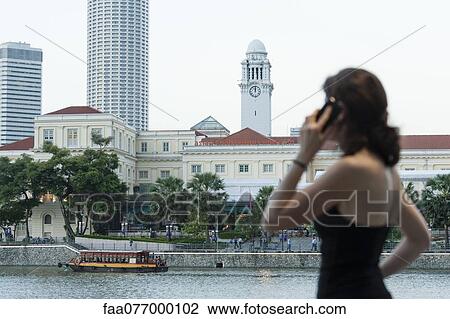 Stock Image - Woman on cell phone looking at view. Fotosearch