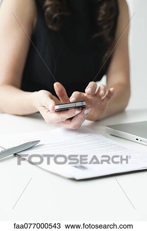 Woman using smartphone, mid section View Large Photo Image Stock Image - Woman using smartphone, mid section. Fotosearch