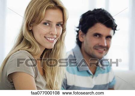 Stock Photo - Young woman at home with husband. Fotosearch