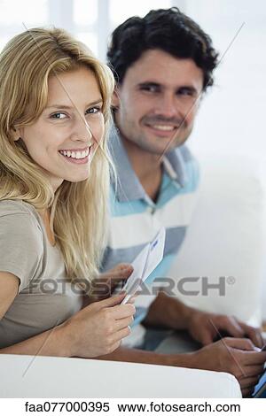 Young woman at home with husband View Large Photo Image Stock Photography - Young woman at home with husband. Fotosearch