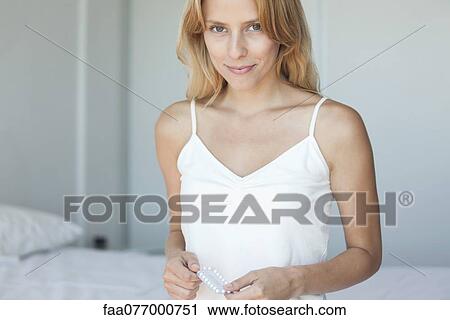 Young woman holding birth control pills View Large Photo Image Stock Image - Young woman holding birth control pills. Fotosearch