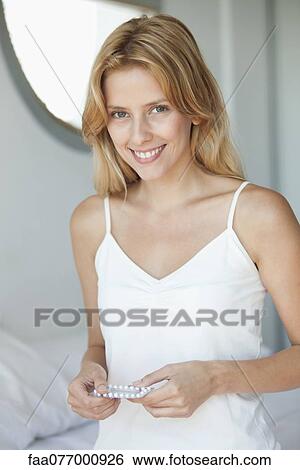 Young woman holding birth control pills, portrait View Large Photo Image Stock Photograph - Young woman holding birth control pills, portrait. Fotosearch