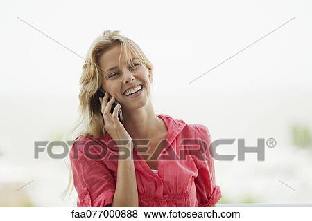 Young woman talking on cell phone, laughing View Large Photo Image Stock Photo - Young woman talking on cell phone, laughing. Fotosearch