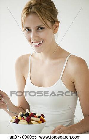 Young woman with bowl of fruit View Large Photo Image Stock Photography - Young woman with bowl of fruit. Fotosearch