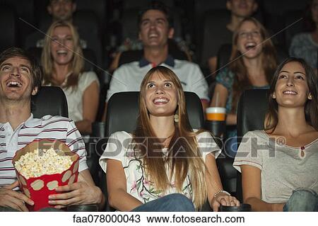 Stock Image - Audience watching movie in theater. Fotosearch