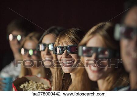 Audience wearing 3-D glasses in movie theater View Large Photo Image Stock Image - Audience wearing 3-D glasses in movie theater. Fotosearch