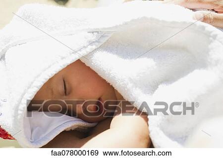 Stock Photo - Baby girl napping under blanket. Fotosearch
