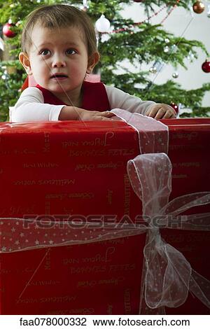 Baby girl opening large Christmas present View Large Photo Image Stock Image - Baby girl opening large Christmas present. Fotosearch