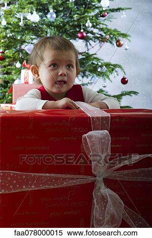 Baby girl opening large Christmas present View Large Photo Image Stock Photography - Baby girl opening large Christmas present. Fotosearch