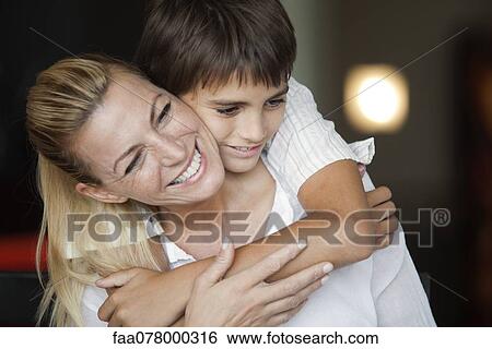 Boy embracing his mother View Large Photo Image Stock Photograph - Boy embracing his mother. Fotosearch