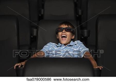 Stock Photograph - Boy enjoying 3-D movie in theater. Fotosearch