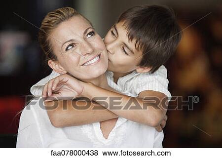 Stock Photo - Boy kissing his mother's cheek. Fotosearch