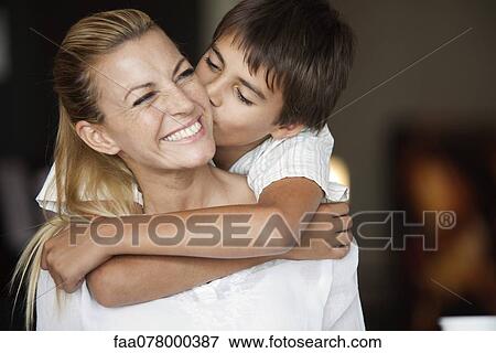 Boy kissing mother's cheek View Large Photo Image Stock Photo - Boy kissing mother's cheek. Fotosearch
