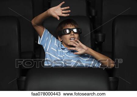 Boy watching 3-D horror movie in theater View Large Photo Image Stock Image - Boy watching 3-D horror movie in theater. Fotosearch