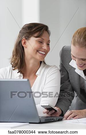 Business associates using smartphone View Large Photo Image Picture - Business associates using smartphone. Fotosearch