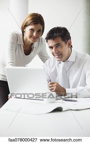 Stock Photo - Business colleagues collaborating. Fotosearch