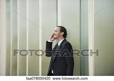 Business executive using cell phone outdoors View Large Photo Image Stock Image - Business executive using cell phone outdoors. Fotosearch