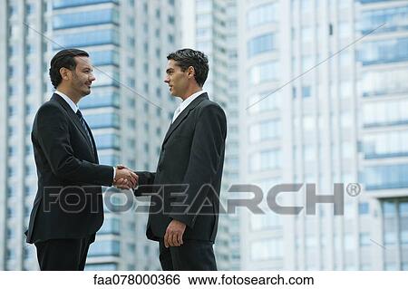 Business executives shaking hands View Large Photo Image Stock Photograph - Business executives shaking hands. Fotosearch
