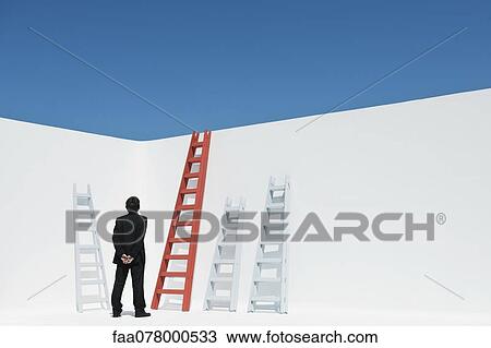 Businessman contemplating ladders, rear view View Large Photo Image Stock Image - Businessman contemplating ladders, rear view. Fotosearch
