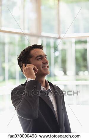 Stock Image - Businessman using cell phone. Fotosearch