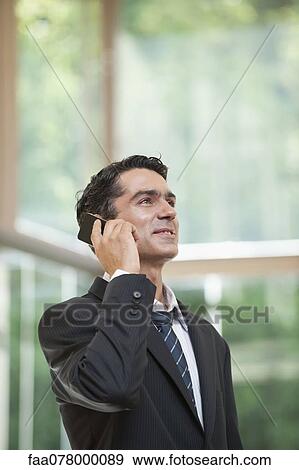 Stock Photo - Businessman using cell phone. Fotosearch