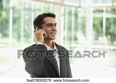 Businessman using cell phone View Large Photo Image Stock Photo - Businessman using cell phone. Fotosearch