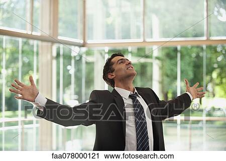 Stock Image - Businessman with arms outstretched. Fotosearch