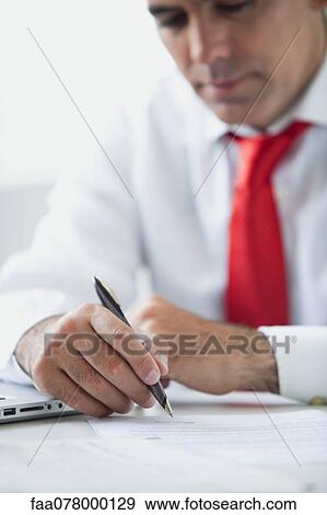 Businessman working at desk View Large Photo Image Stock Photo - Businessman working at desk. Fotosearch