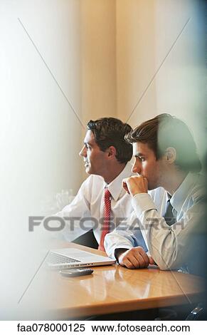 Stock Photography - Businessmen in meeting. Fotosearch