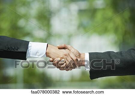 Stock Image - Businessmen shaking hands. Fotosearch