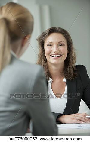 Businesswoman meeting with client View Large Photo Image Stock Image - Businesswoman meeting with client. Fotosearch