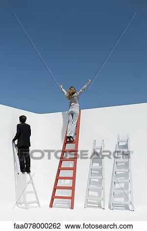 Businesswoman standing at top of ladder with arms raised in air View Large Photo Image Stock Image - Businesswoman standing at top of ladder with arms raised in air. Fotosearch