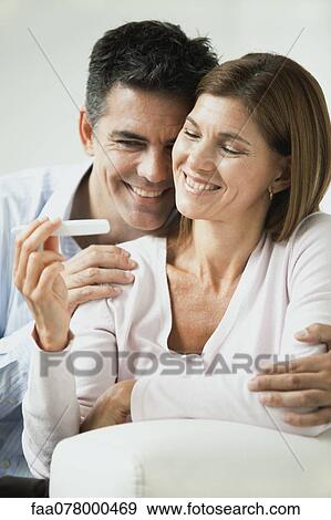 Couple pleased with pregnancy test result View Large Photo Image Stock Photo - Couple pleased with pregnancy test result. Fotosearch