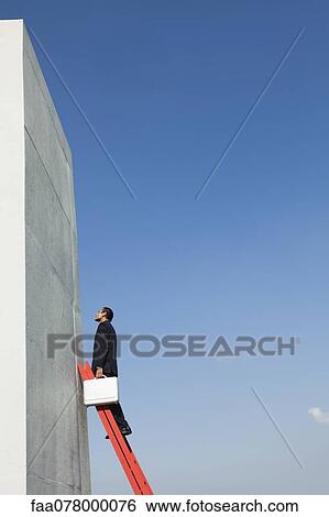 Determined business professionals climb ladder of success despite challenges View Large Photo Image Stock Photograph - Determined business professionals climb ladder of success despite challenges. Fotosearch