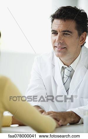 Doctor listening attentively to patient during consultation View Large Photo Image Stock Image - Doctor listening attentively to patient during consultation. Fotosearch