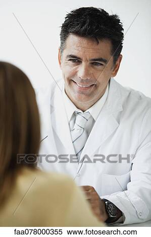 Doctor meeting with patient for consultation View Large Photo Image Stock Photography - Doctor meeting with patient for consultation. Fotosearch