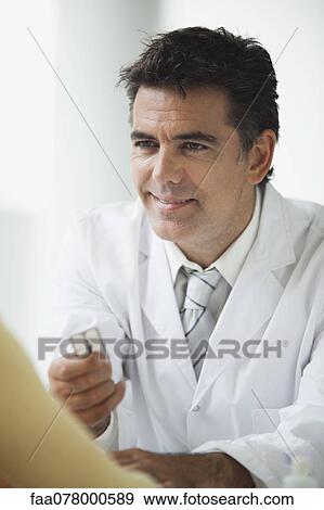 Doctor providing patient with prescription drugs View Large Photo Image Stock Photo - Doctor providing patient with prescription drugs. Fotosearch