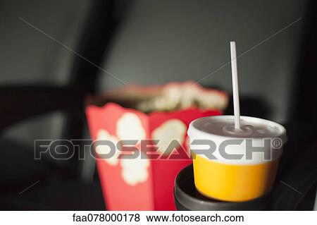Stock Photo - Drink and popcorn in movie theater. Fotosearch