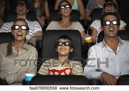 Family watching 3-D movie in theater View Large Photo Image Stock Photo - Family watching 3-D movie in theater. Fotosearch