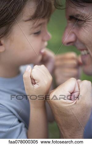 Father and son goofing off with fists clenched View Large Photo Image Stock Photography - Father and son goofing off with fists clenched. Fotosearch