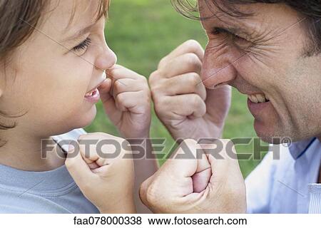 Stock Photo - Father and son playfighting. Fotosearch
