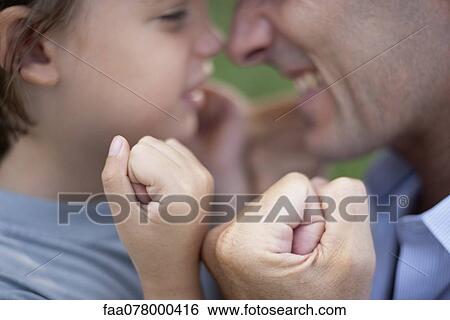 Father and son with fists clenched View Large Photo Image Stock Photograph - Father and son with fists clenched. Fotosearch