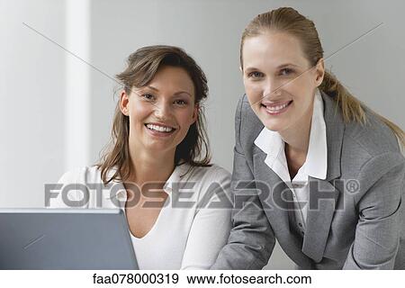 Stock Photo - Female business associates, portrait. Fotosearch