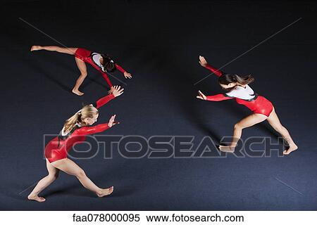 Stock Photography - Female gymnasts practicing floor routine. Fotosearch