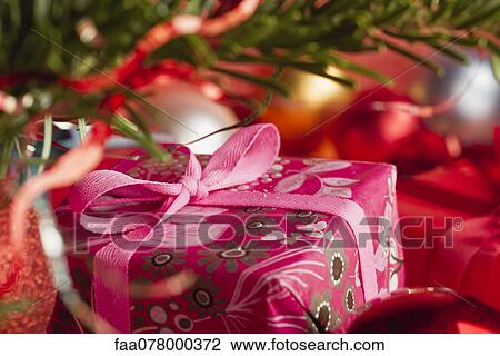 Stock Image - Festively wrapped Christmas gift, cropped. Fotosearch