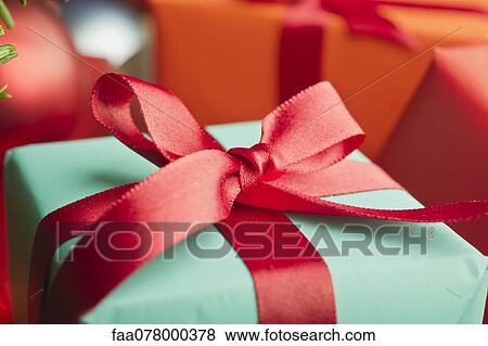 Festively wrapped Christmas gift, close-up View Large Photo Image Stock Photo - Festively wrapped Christmas gift, close-up. Fotosearch