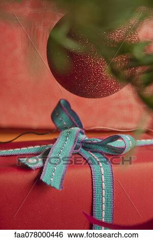 Stock Photograph - Festively wrapped Christmas gift, close-up. Fotosearch