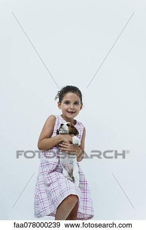 Girl holding beagle puppy View Large Photo Image Stock Photo - Girl holding beagle puppy. Fotosearch